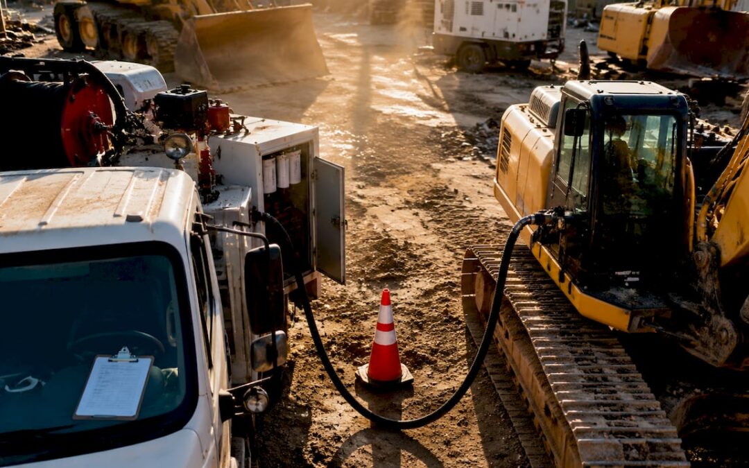 Fuel delivery truck refueling heavy machinery