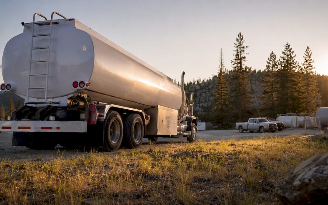 Utility manager reviewing diesel delivery contract by tanker truck