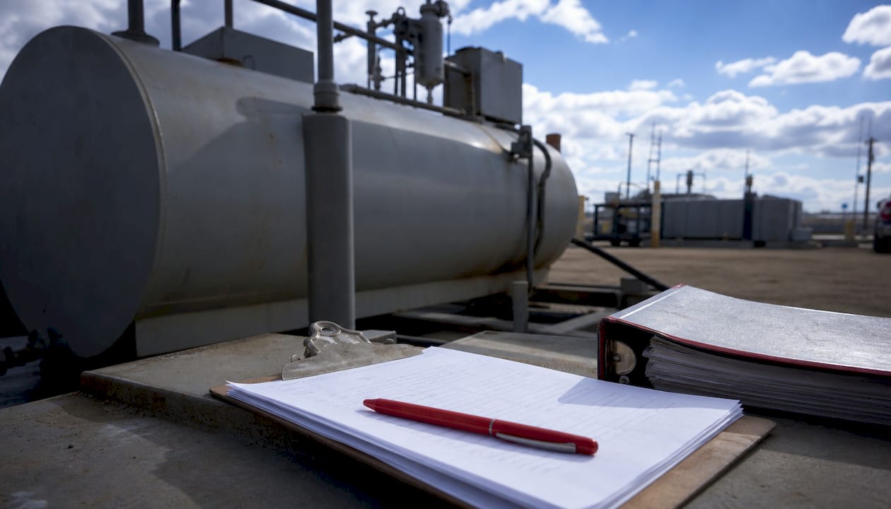 Clipboard with fuel delivery paperwork on metal platform