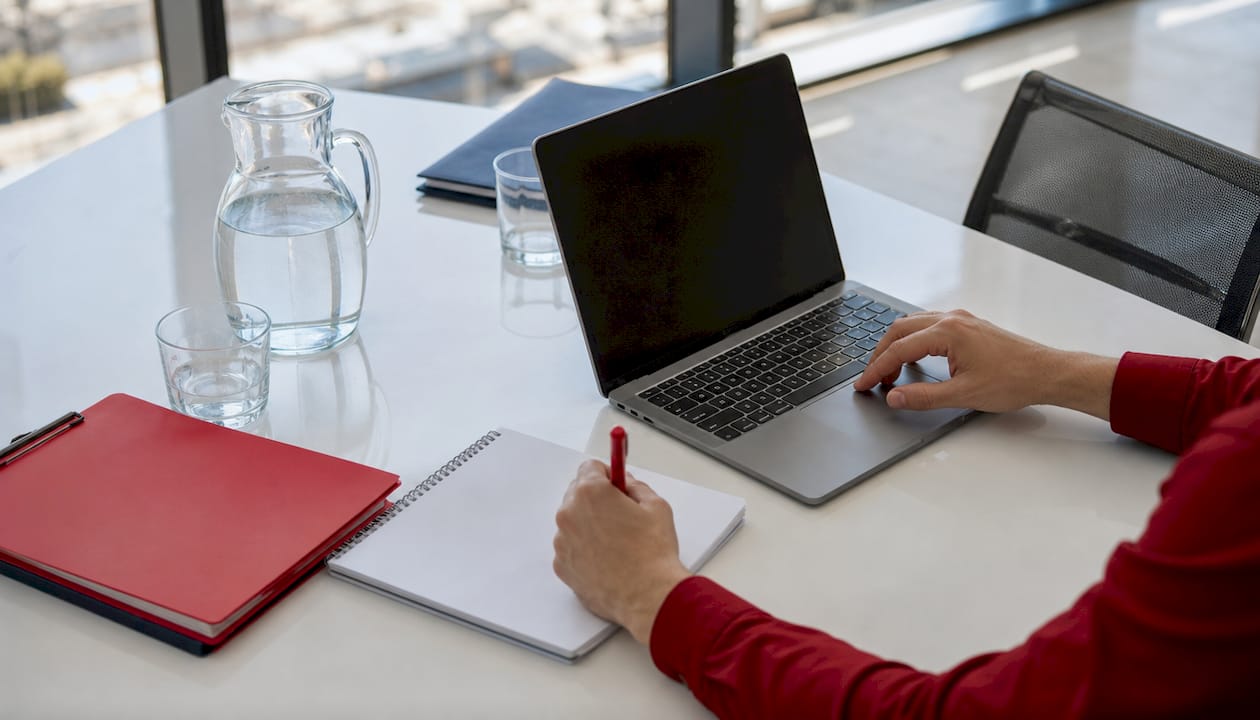 Hands working on fuel delivery planning at conference table