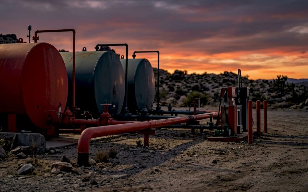 Remote oil field fuel storage tanks at dawn