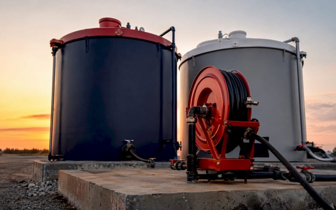 Industrial fuel storage tanks with red and black caps