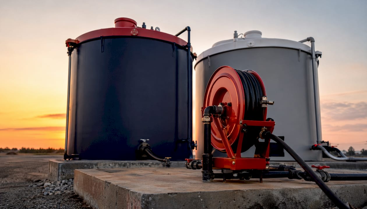 Industrial fuel storage tanks with red and black caps