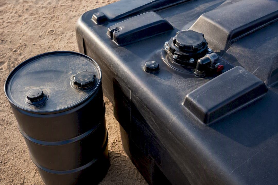 Close-up of diesel fuel drum and tote outdoors
