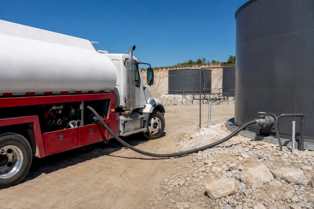 Fuel delivery truck refueling storage tanks