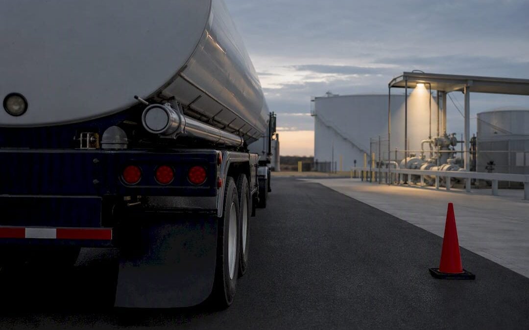 Unmarked tanker approaching an industrial access gate