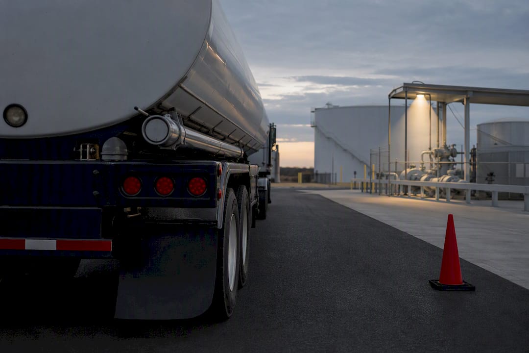 Unmarked tanker approaching an industrial access gate