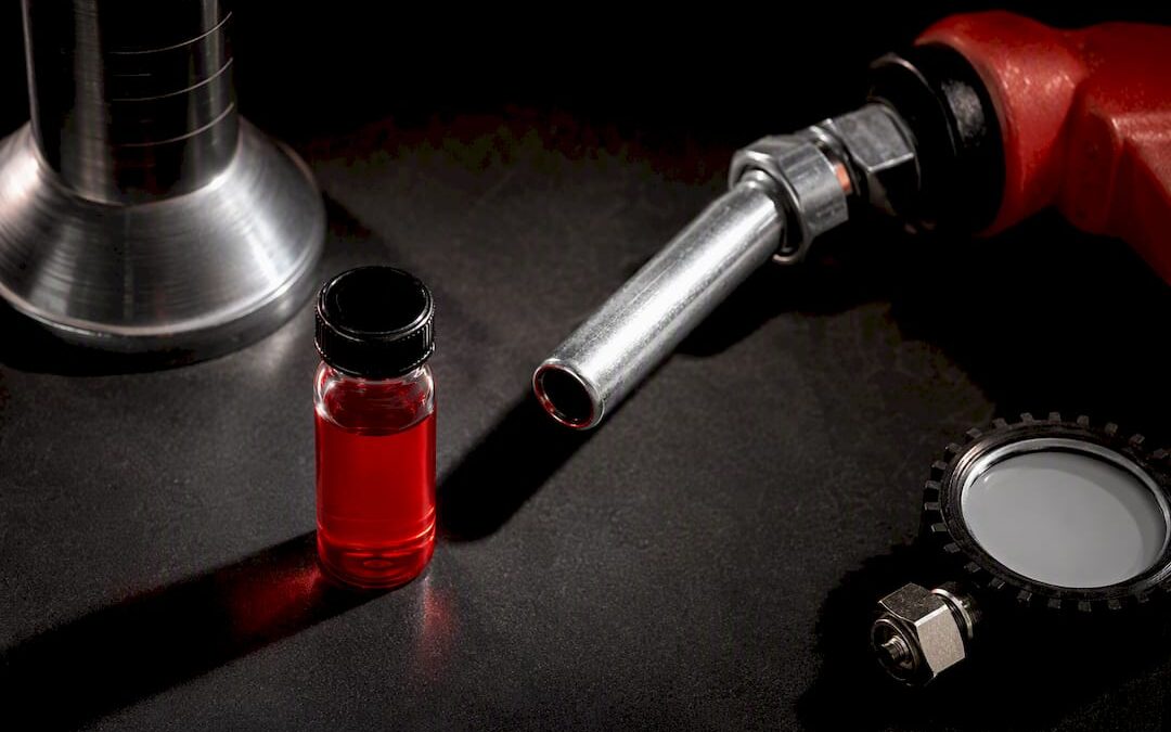 Red-dyed diesel sample beside dispensing nozzle