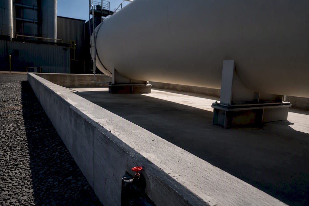Unbranded fuel tank inside containment berm