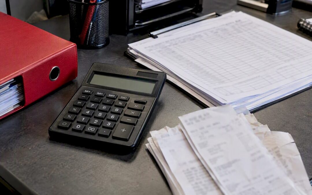 Fleet mileage and fuel records beside calculator