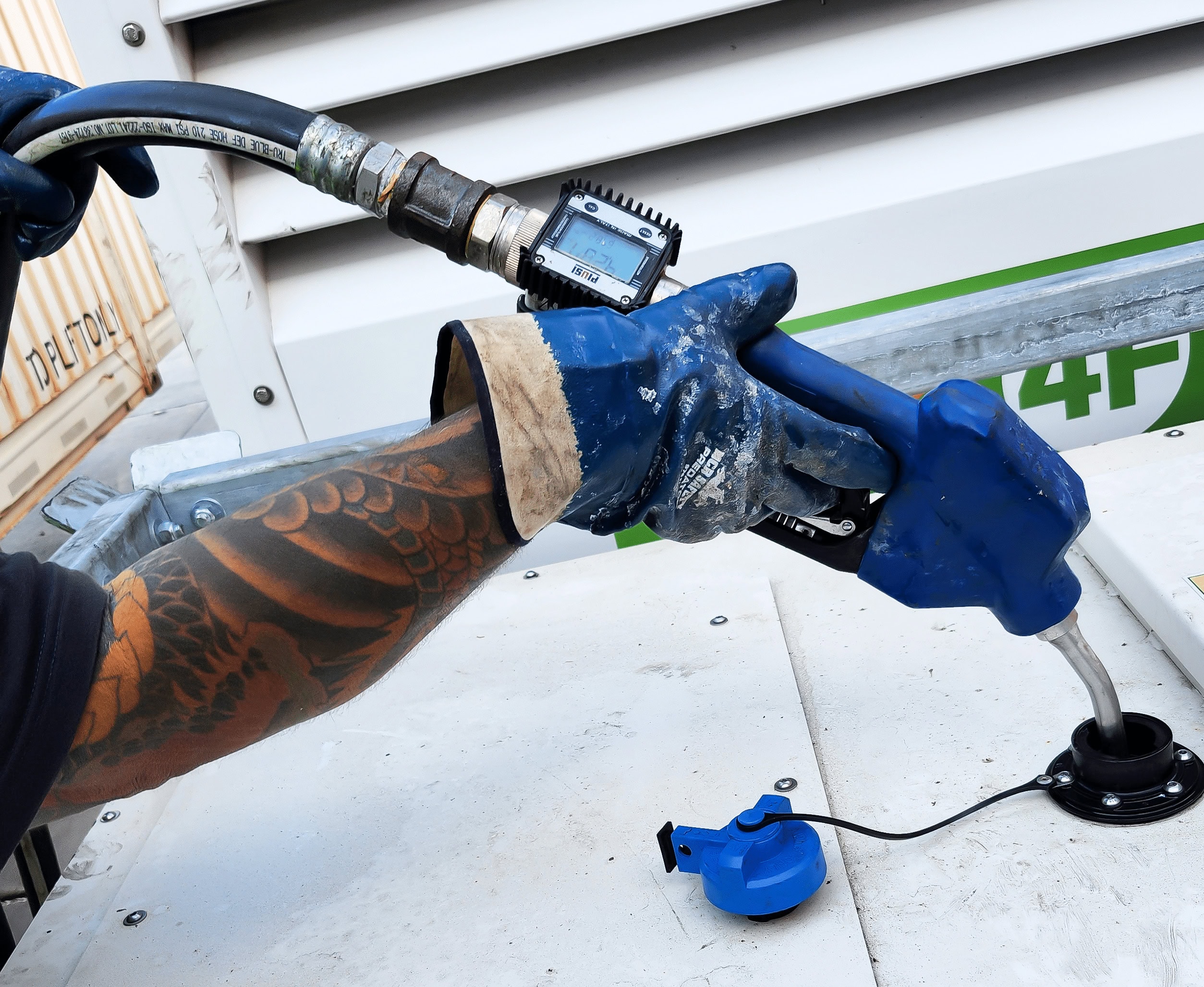 delivery driver fuels tank with diesel 2 fuel