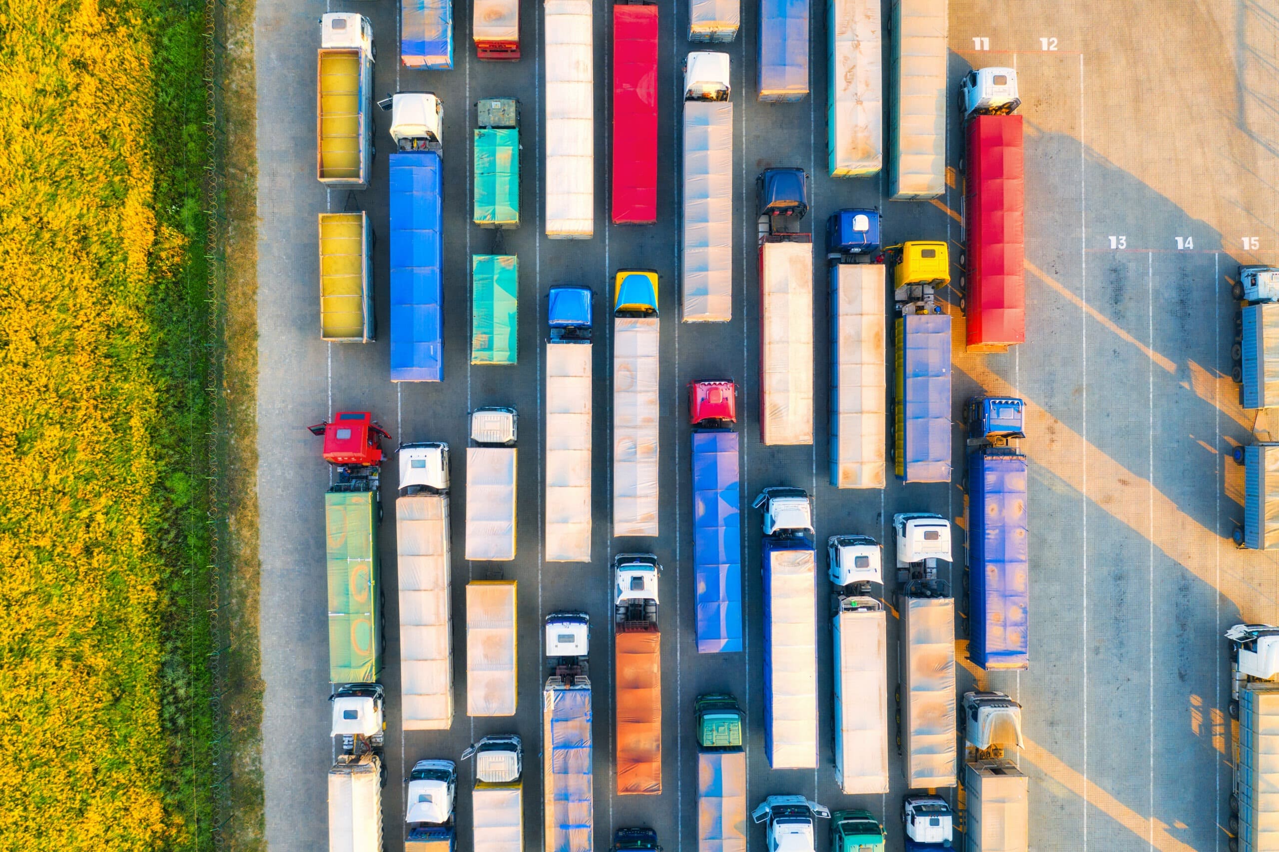 Aerial view of colorful trucks in terminal at sunset in summer